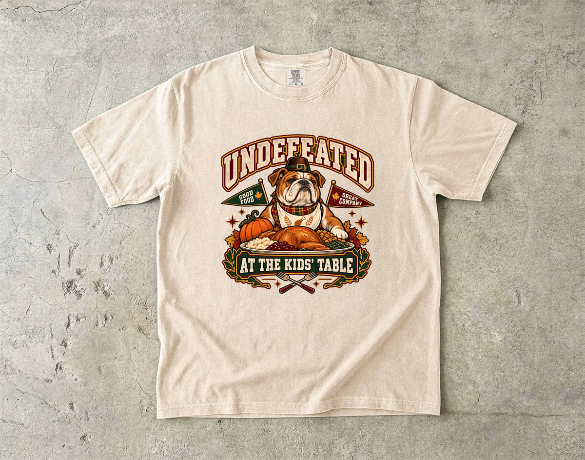 Undefeated at the Kids' Table Funny Thanksgiving T-Shirt | Vintage Bulldog Family Dinner Tee | Comfort Colors 1717 Garment-Dyed Unisex Shirt | Dog Lover Gift
