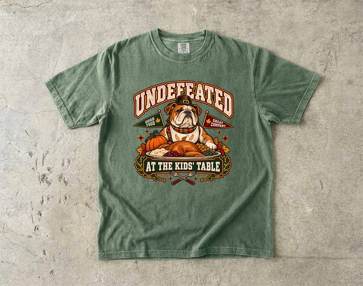 Undefeated at the Kids' Table Funny Thanksgiving T-Shirt | Vintage Bulldog Family Dinner Tee | Comfort Colors 1717 Garment-Dyed Unisex Shirt | Dog Lover Gift
