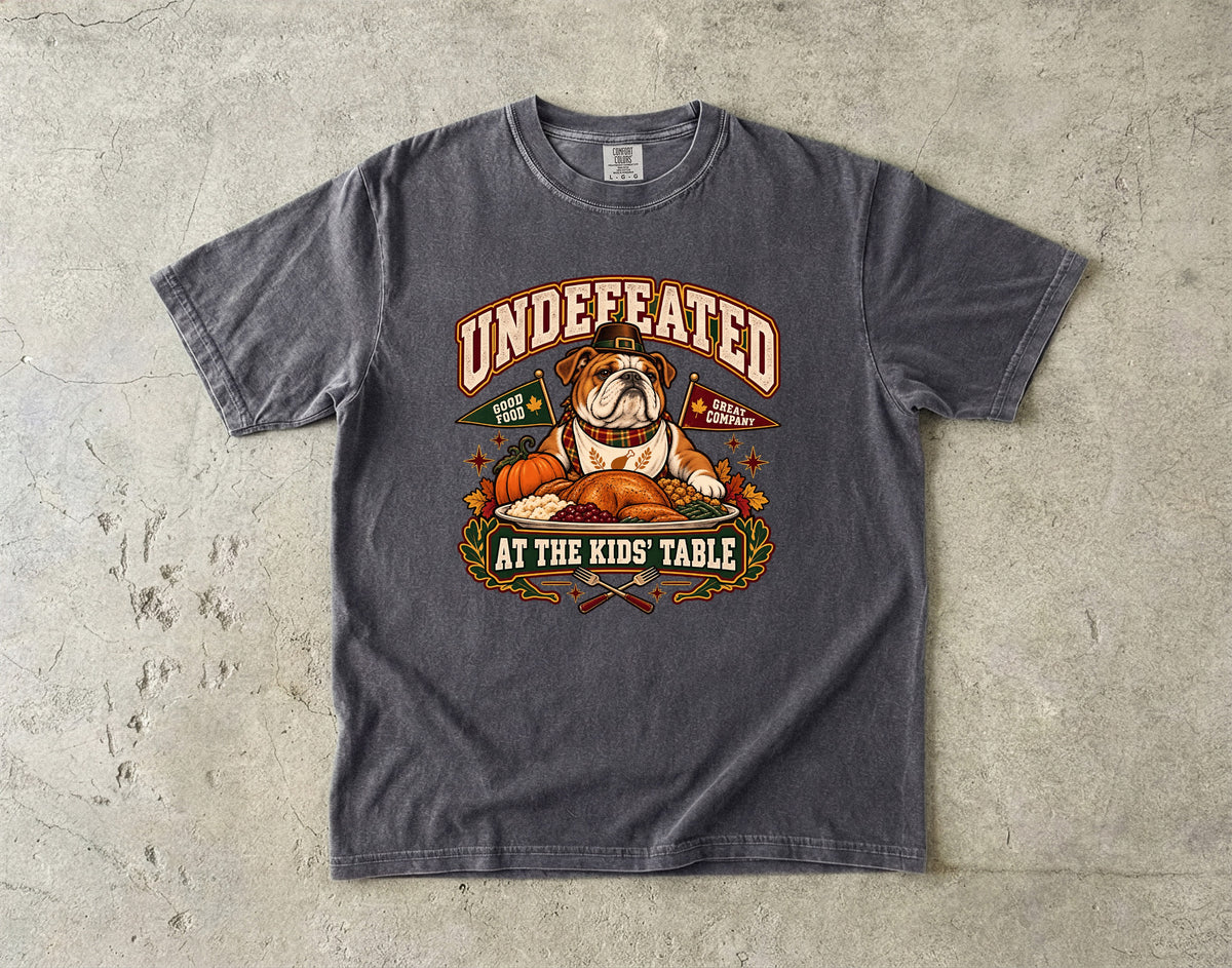 Undefeated at the Kids' Table Funny Thanksgiving T-Shirt | Vintage Bulldog Family Dinner Tee | Comfort Colors 1717 Garment-Dyed Unisex Shirt | Dog Lover Gift