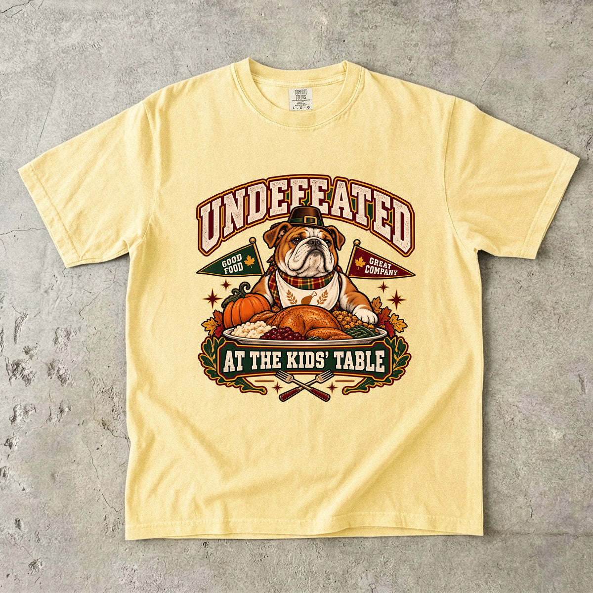 Undefeated at the Kids' Table Funny Thanksgiving T-Shirt | Vintage Bulldog Family Dinner Tee | Comfort Colors 1717 Garment-Dyed Unisex Shirt | Dog Lover Gift